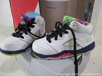 Full view of both toddler sneakers showing uppers, midsoles, laces and box.