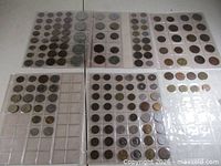 Overview of six coin album sheets laid out
