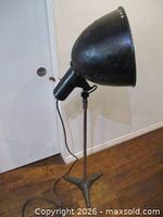 Side view of flood light on stand showing overall form and base