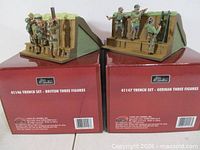 Both Britains boxed trench sets displayed atop their original red boxes, showing product numbers 41146 and 41147