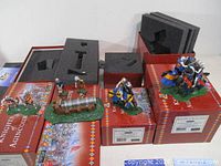 All four Britains Knights of Agincourt sets on boxes with figures and cannon visible