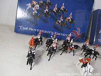 Mounted Household Cavalry figures in front of Sovereign’s Escort box