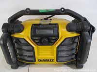 Front view of Dewalt DCR015 radio/charger showing speakers, controls and protective frame