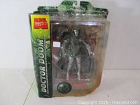 Front view of packaged Doctor Doom figure and base