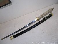 Full view of sword and black scabbard