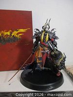 Action figure displayed with art book behind
