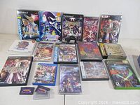 Overall view of 16 boxed games plus two DS cartridges