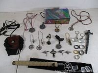 Full lot overview on table showing jewelry box, necklaces, pouches, wand, rings, pendants, crystals
