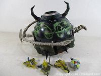 Unicron in planet mode with ring segments, horns, three yellow/grey jet Mini-Cons, Dead End sphere, missiles displayed