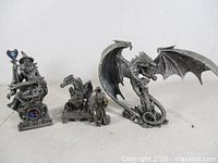 All four pewter figurines lined up for scale and overview
