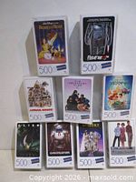 All nine sealed puzzles stacked to show titles