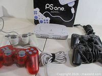 Console, box, white/grey, red and black controllers visible