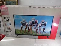 Front of retail box showing RCA 55" LED TV image and specs