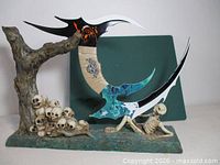 Full view of Bat'leth mounted on skull stand with tree and skeleton
