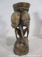 Front view showing two beast heads and candle cup