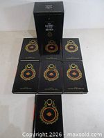 Books removed from slipcase laid out showing covers