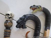 Close-up of skull, dragon, and cobra handles