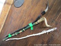 All three staffs laid on table showing length, colors, and tips