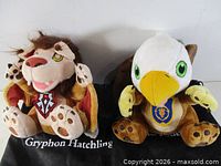 Front view of both plush toys seated on their respective sacks