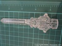 Full view of clear plastic Transformers key on measurement grid