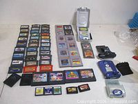 Overview of all cartridges, console, memory card, e-Reader and adapter laid out on table