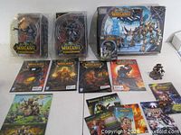 Overview of lot showing sealed figures, Mega Bloks box, comics, booklets and loose figures