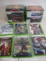 Overall lot showing two stacks of Xbox 360 games and eight cases laid out front-on