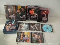 Overall lot showing DVDs, game, CDs and loose disc