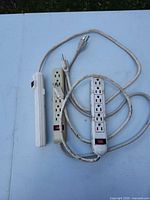Front view of three power strips showing outlets and switches