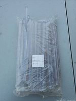 Full view of sealed plastic bag containing glue sticks