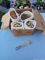 Open box showing pouches of chopsticks and rests plus loose pair and rest