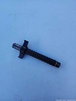 Baton collapsed showing rubber grip, end cap, and side guard
