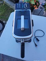 Top view showing lid with viewing window, temperature dial and power cord