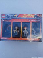Front of LEGO Jurassic World minifigure pack showing three minifigures and branding