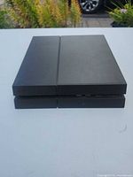 Front view of PS4 console showing vents and USB ports