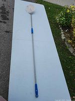 Full view of entire pizza peel showing length and blue grips