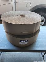 Two stacked rolls of corrugated cardboard wrap on table