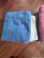 Stack of blue, cream and additional towels