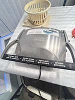 Closed view of stainless steel Cuisinart Griddler showing branding and function labels