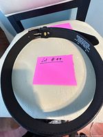 Coiled black faux leather belt overall view