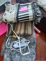Stack showing three blankets and electric controller