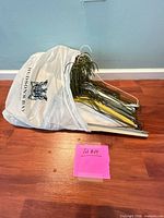 Pile of metal wire hangers in shopping bag on floor
