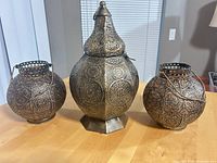 All three antique copper pierced metal lanterns displayed together