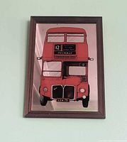 Front view of entire framed mirror showing bus graphic