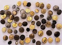 Overview of assorted brass and metal buttons