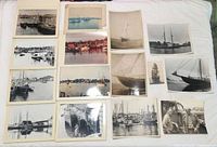 Overview of 13 mounted prints laid out on white surface
