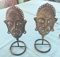 Front view of both cast brass face candleholders