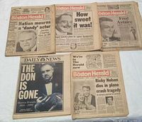 Five newspapers laid out showing all front pages and headlines