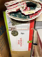 Tree skirt folded atop tree box, model 741 Virginia Pine visible