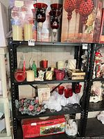 Full shelving view showing various candle holders, candles, décor pieces